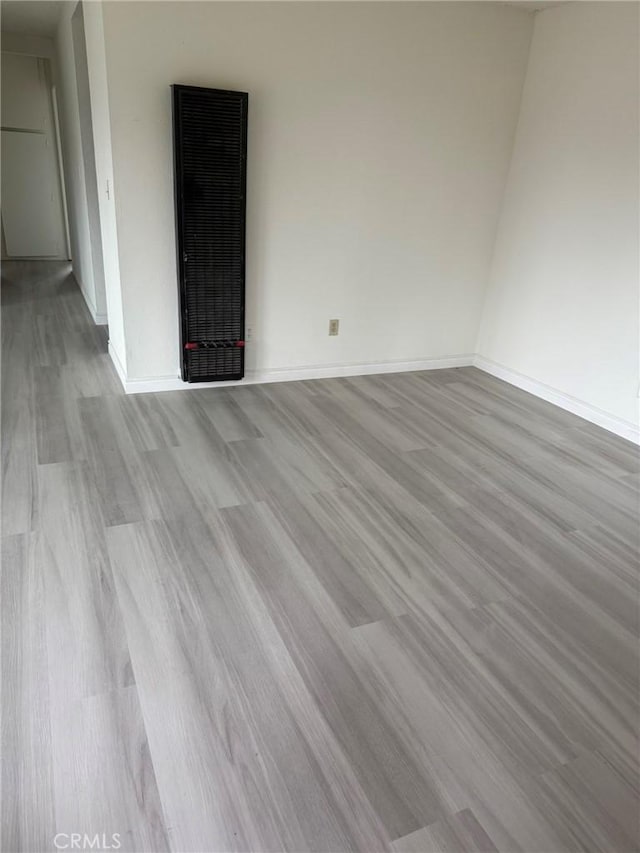 empty room with wood finished floors and baseboards