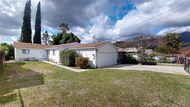 single story home with a garage, driveway, a front lawn, and fence