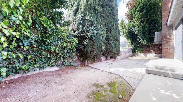 view of yard with fence and a patio