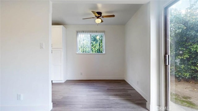 unfurnished room with ceiling fan, baseboards, and wood finished floors