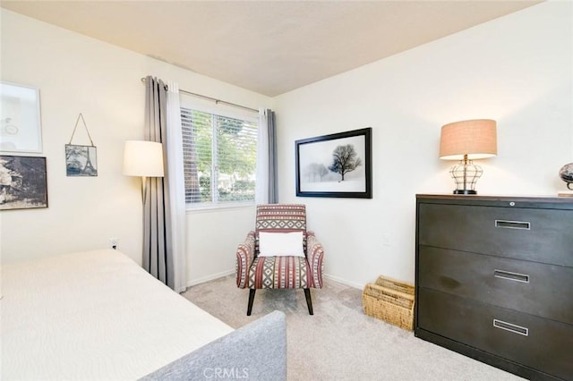 bedroom featuring light colored carpet and baseboards