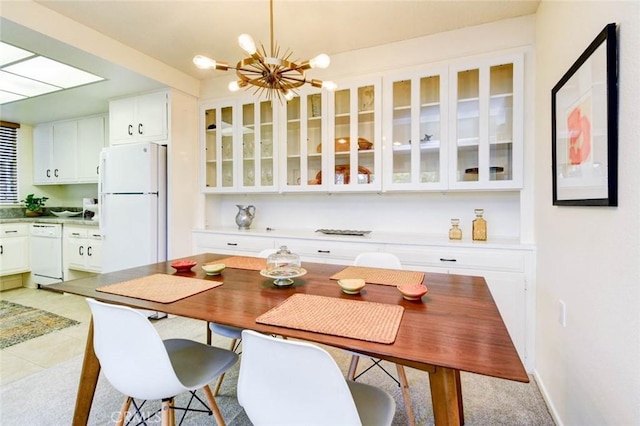 kitchen featuring glass insert cabinets, white appliances, white cabinetry, and an inviting chandelier