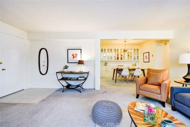 living area with carpet and a notable chandelier