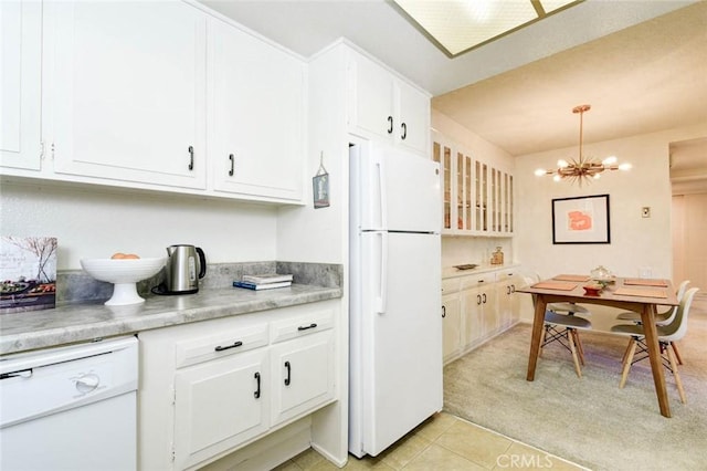 kitchen featuring light countertops, white appliances, white cabinetry, and an inviting chandelier