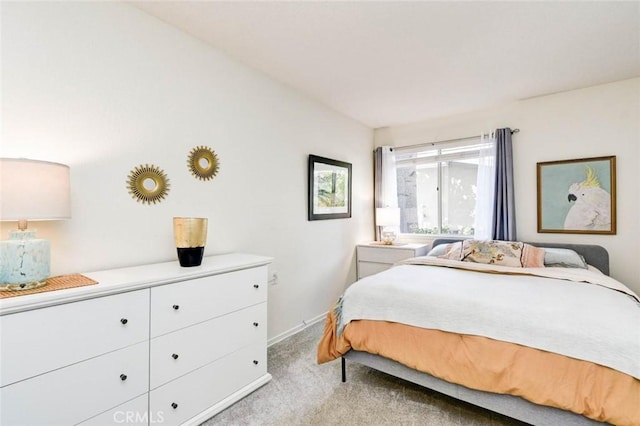 bedroom with light carpet and baseboards