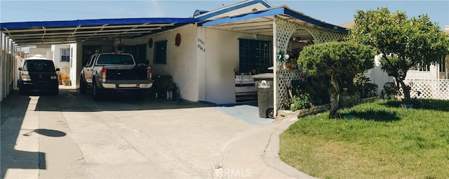ranch-style house featuring a carport, driveway, and electric panel