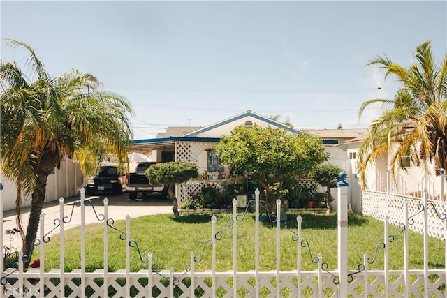 exterior space with driveway and a fenced front yard