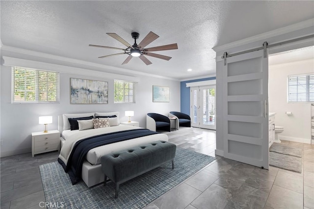 bedroom with ensuite bathroom, ornamental molding, a barn door, a textured ceiling, and baseboards