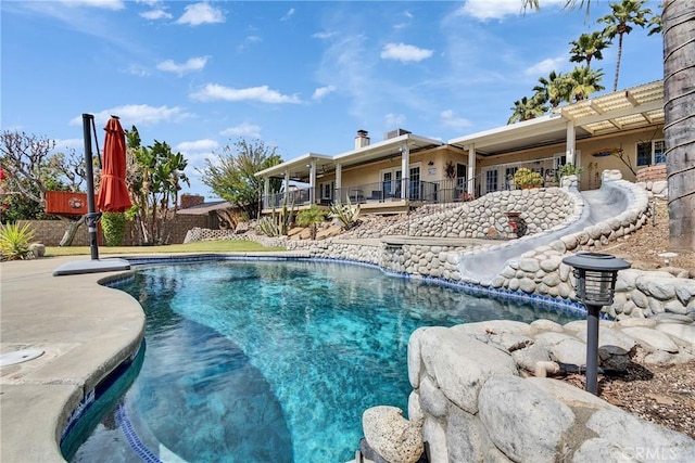 outdoor pool with a patio area and fence