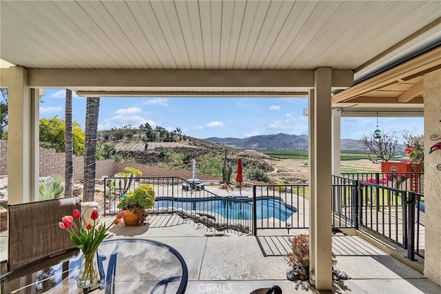 view of pool with a fenced in pool, a patio, and a mountain view