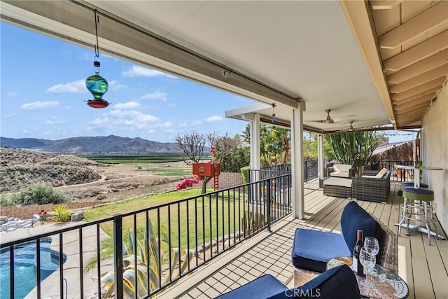 balcony featuring a mountain view and outdoor lounge area