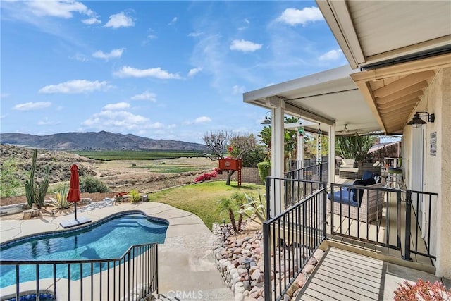 view of patio / terrace with a mountain view and an outdoor pool