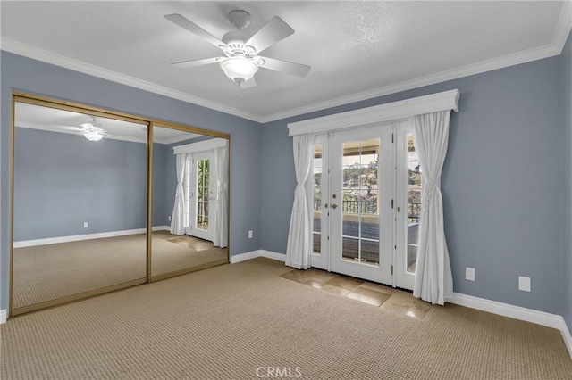 interior space with carpet floors, access to exterior, baseboards, and ornamental molding