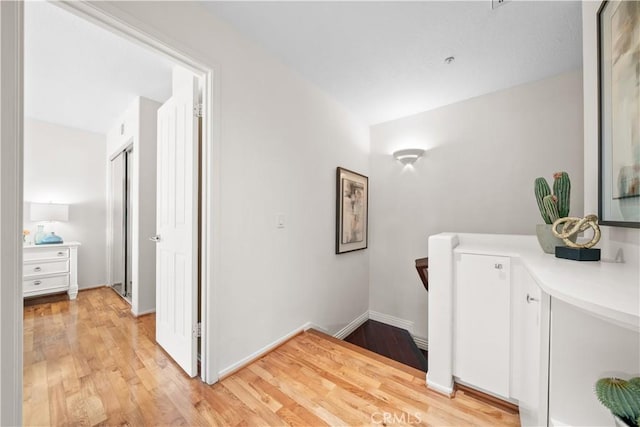 bathroom with baseboards, wood finished floors, and vanity