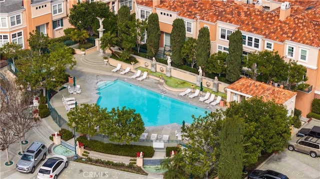 community pool featuring a residential view and fence