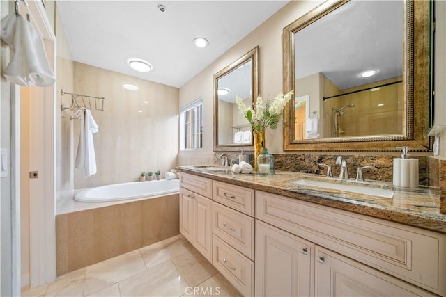 full bath featuring tile patterned flooring, walk in shower, a sink, and a bath