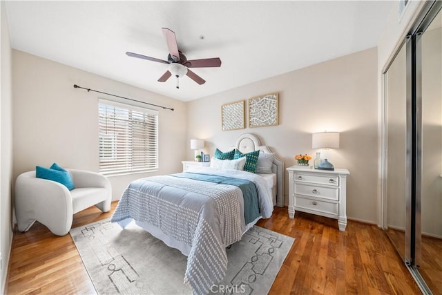 bedroom with ceiling fan, a closet, and wood finished floors