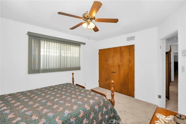 carpeted bedroom with visible vents and a ceiling fan