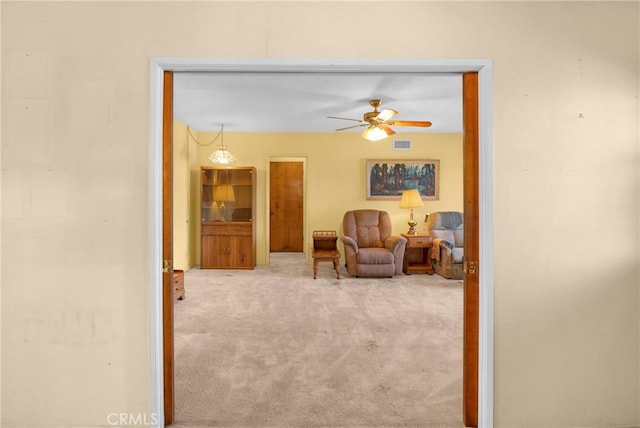 living area with ceiling fan, carpet, and visible vents