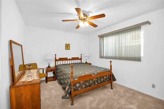 carpeted bedroom with a ceiling fan and baseboards