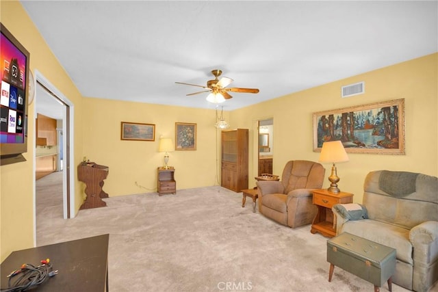 sitting room featuring a ceiling fan, carpet, and visible vents