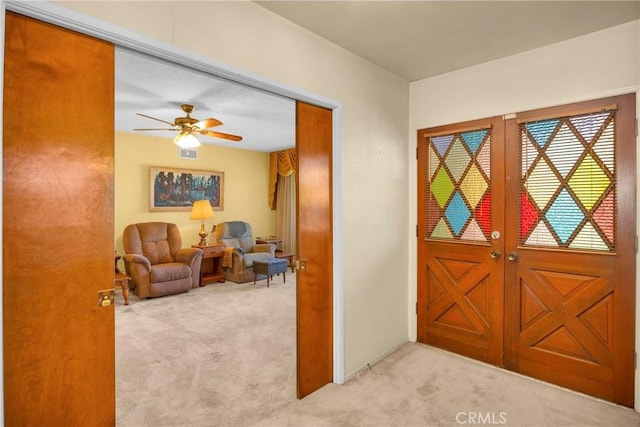 entryway featuring carpet floors and a ceiling fan