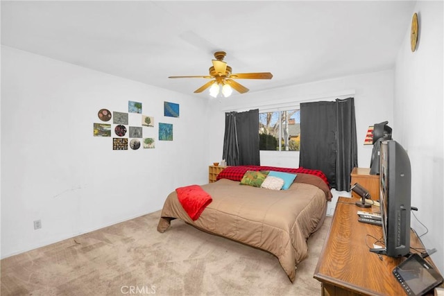 bedroom featuring a ceiling fan and light colored carpet