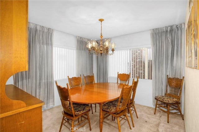 dining space with a notable chandelier and light colored carpet