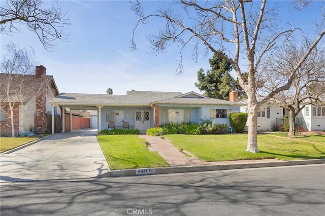 ranch-style home with a front lawn, an attached carport, and concrete driveway