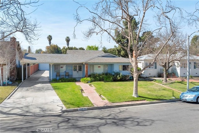 single story home featuring a carport, a front lawn, driveway, and stucco siding