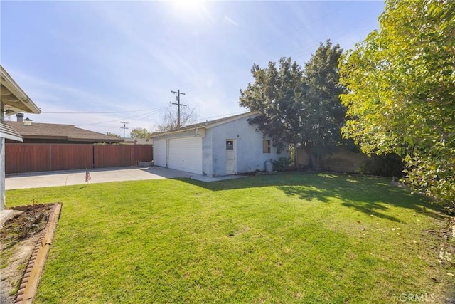 view of yard featuring a patio area, fence, and an attached garage