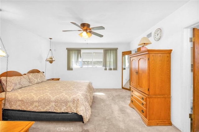 bedroom with a ceiling fan and light colored carpet