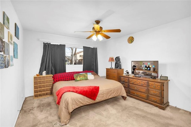 bedroom with a ceiling fan and light colored carpet