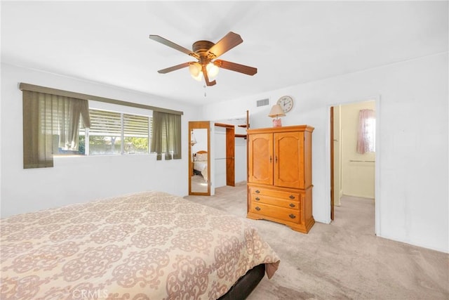 bedroom featuring light carpet, ceiling fan, and visible vents