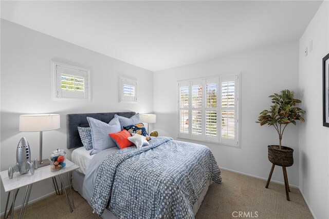 carpeted bedroom with baseboards