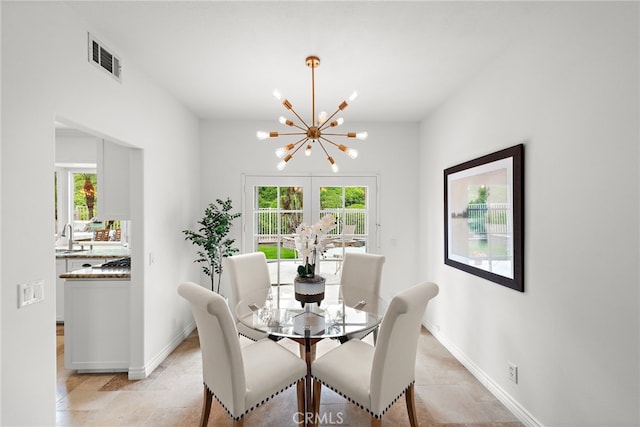 dining area featuring baseboards, a notable chandelier, and visible vents