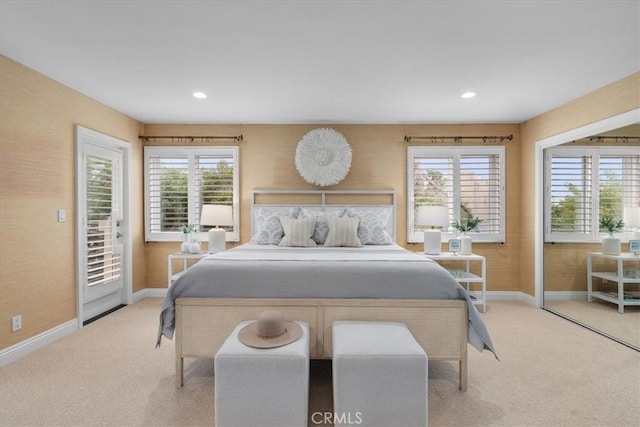 bedroom with access to exterior, recessed lighting, light colored carpet, and baseboards