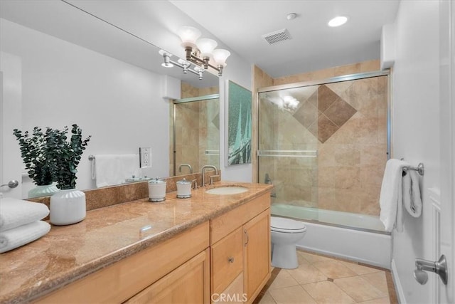 bathroom featuring visible vents, toilet, tile patterned floors, combined bath / shower with glass door, and vanity
