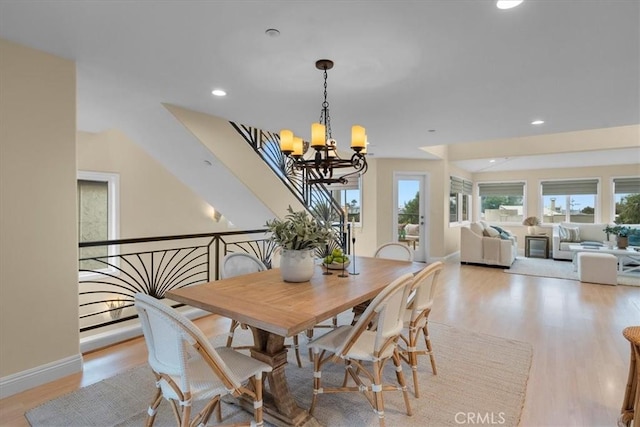 dining space with a notable chandelier, recessed lighting, baseboards, and light wood finished floors