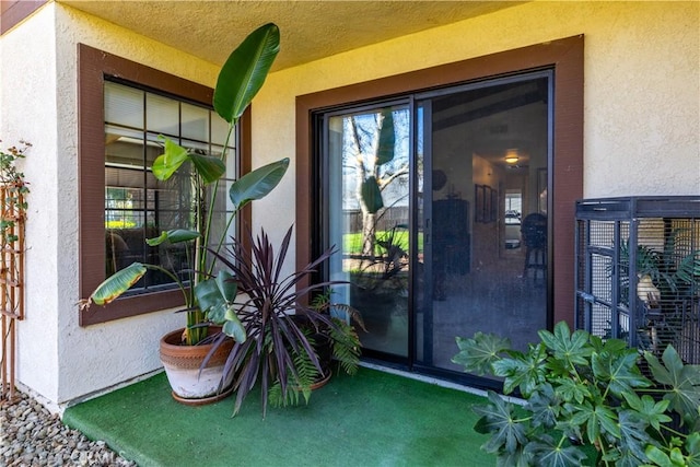 property entrance featuring stucco siding