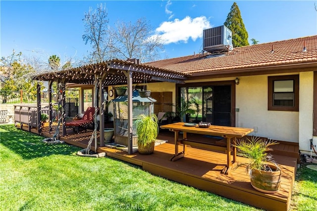 rear view of property featuring stucco siding, a lawn, central AC, a pergola, and a wooden deck