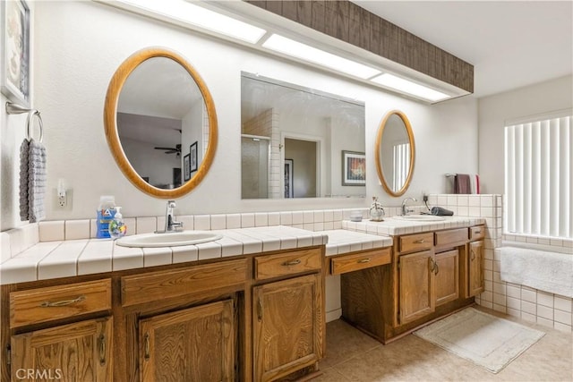 full bath featuring a shower with door, vanity, and tile patterned floors