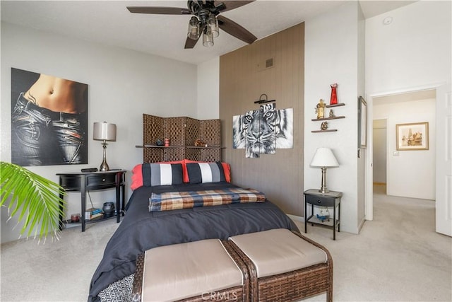 bedroom with carpet floors, visible vents, and a ceiling fan