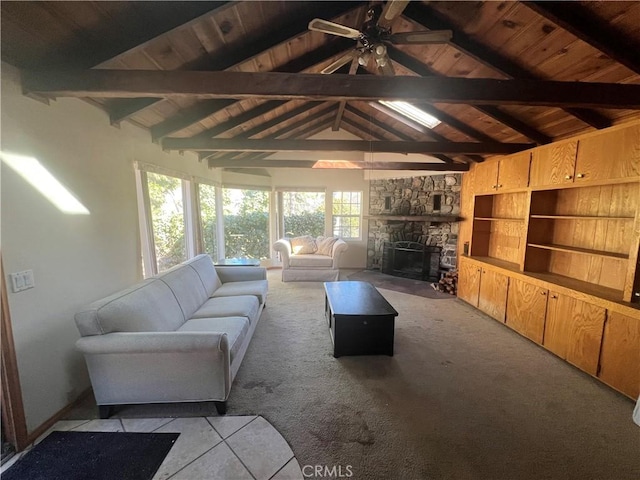 unfurnished living room featuring wood ceiling, light carpet, vaulted ceiling with beams, and a stone fireplace