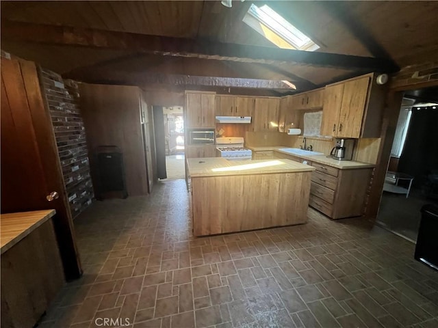 kitchen with lofted ceiling with beams, a kitchen island, a sink, white range with gas stovetop, and under cabinet range hood