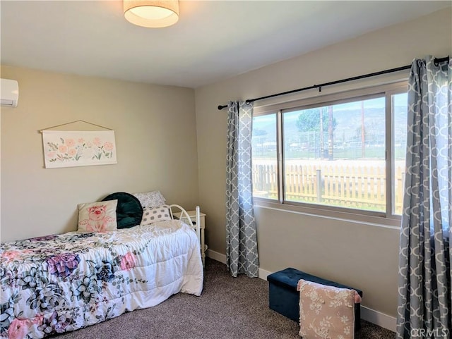 carpeted bedroom with a wall unit AC and baseboards