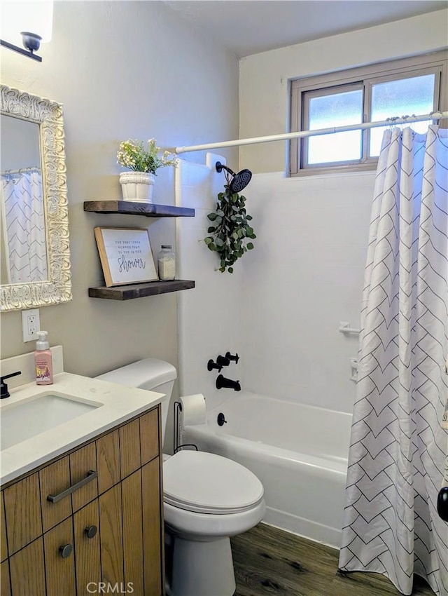 full bath with toilet, wood finished floors, vanity, and shower / tub combo with curtain