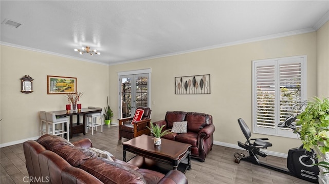 living area with baseboards, wood finished floors, visible vents, and crown molding