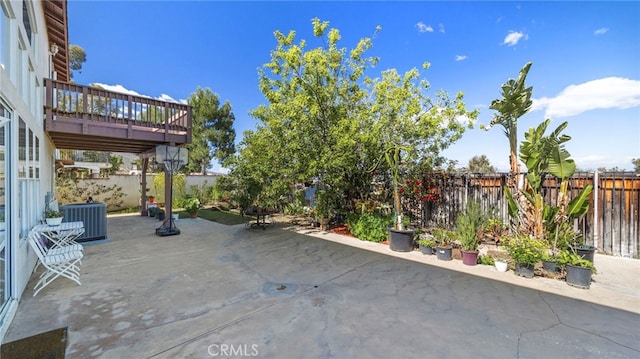 view of patio featuring a deck, a fenced backyard, and central air condition unit