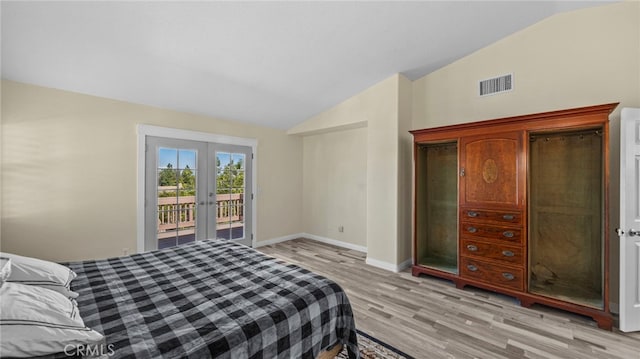 bedroom with light wood finished floors, visible vents, lofted ceiling, access to outside, and french doors